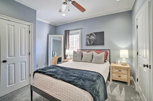 a bedroom with blue walls and a bed with pillows at Modern Retreat about half Mi to Bryant-Denny Stadium in Tuscaloosa
