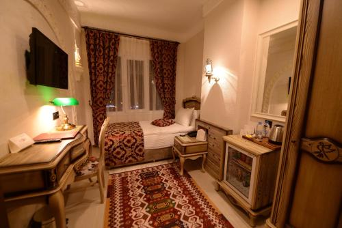 A bed or beds in a room at RAYMAR HOTELS MARDİN