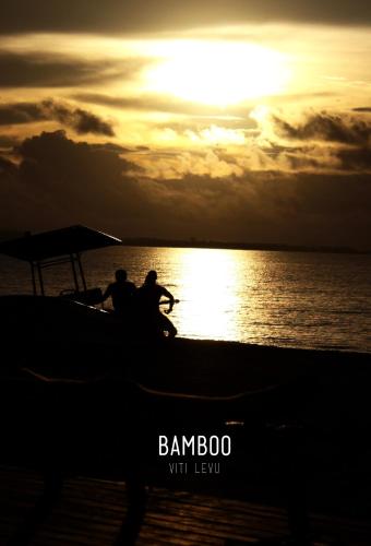two people on a boat in the water at sunset at Bamboo Backpackers in Nadi
