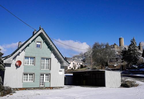 a house with a garage in the snow at Gästehaus Fuchshof in Nürburg