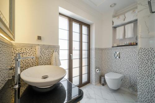 a bathroom with a sink and a toilet at Residence City Garden - Certificate of Excellence Top 10 BEST Five-Stars City Hotels for 2024 awarded by HTIF in Plovdiv