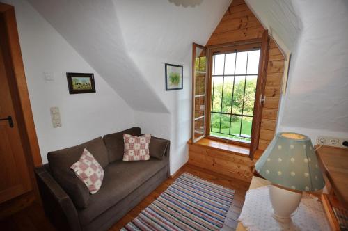 a living room with a couch and a window at Altes Gehöft am Lormanberg in Kirchberg an der Raab