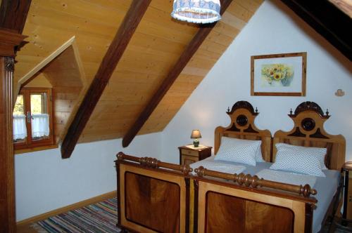 a bedroom with two beds in a attic at Altes Gehöft am Lormanberg in Kirchberg an der Raab