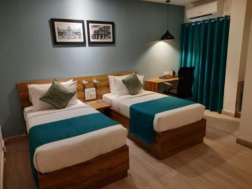 Ένα ή περισσότερα κρεβάτια σε δωμάτιο στο Regenta INN Grand Koramangala by Royal Orchid Hotels