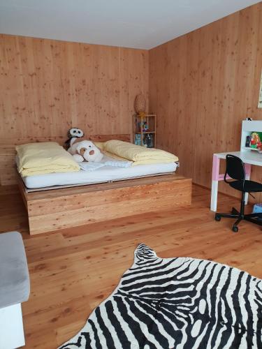 a bedroom with a bed with a stuffed animal on it at Chalet Breithorn- Perfect for Holiday with Amazing View! in Obergesteln