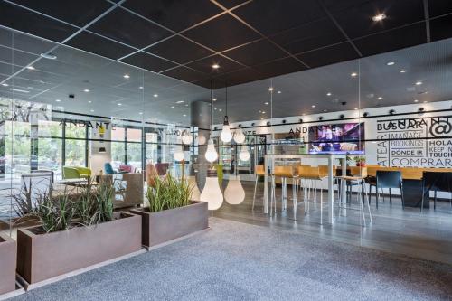 a restaurant with a dining area with tables and chairs at Andante Hotel in Barcelona