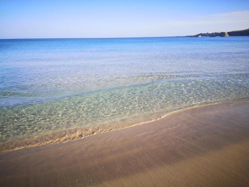 a view of the beach with the sand and water at Nido Colorato Guest House in Fontane Bianche