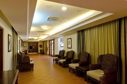 a waiting room in a hospital with chairs and a waiting room at White Sands Hotel in Dar es Salaam