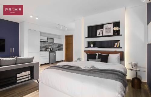 a white bedroom with a large bed and a television at Prime Select El Batal in Cairo