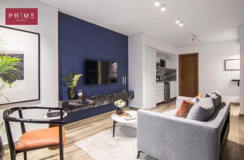 a living room with a blue accent wall at Prime Select El Batal in Cairo