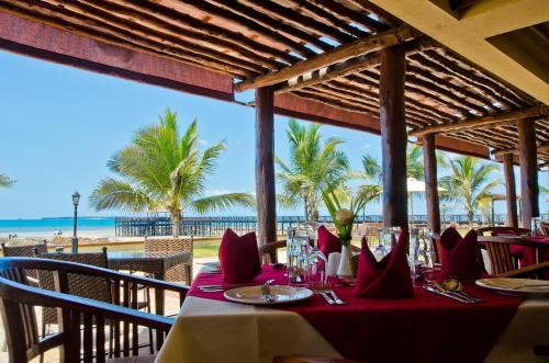 a table at a restaurant with a view of the beach at White Sands Hotel in Dar es Salaam