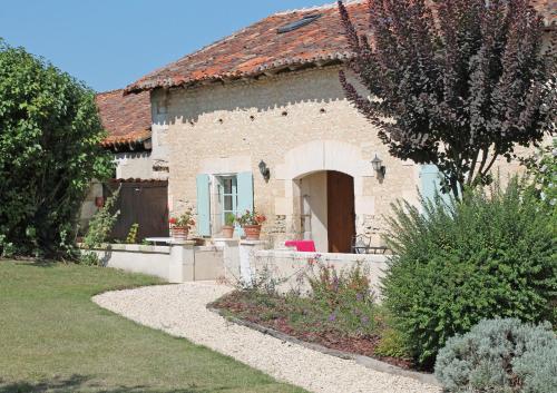 a stone house with a pathway leading to it at Manoir de Longeveau in Pillac