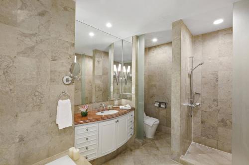 a bathroom with a toilet and a sink and a shower at Ascott Jakarta in Jakarta