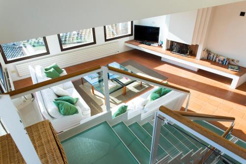 an overhead view of a living room with white furniture at Zafferano Rooftop Terrace Tower House in San Gimignano