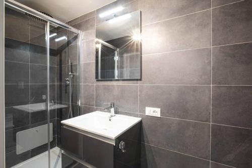 a bathroom with a sink and a mirror at Unforgettable Split Level Jacuzzi Suite Navona - Top Collection in Rome