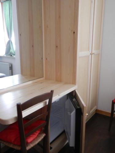 a cabinet with a desk and a chair in a room at Hotel Villa Stella in Cascia