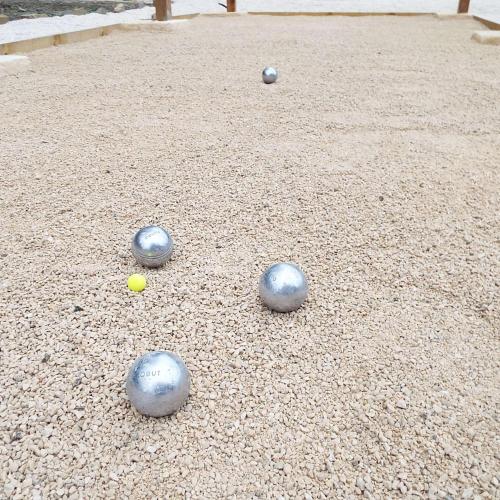 a group of balls sitting on the ground at La Maison du Moulin de Tartay in Avignon
