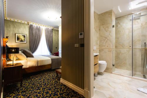a hotel room with a bed and a shower at Envy Hotel in Durrës