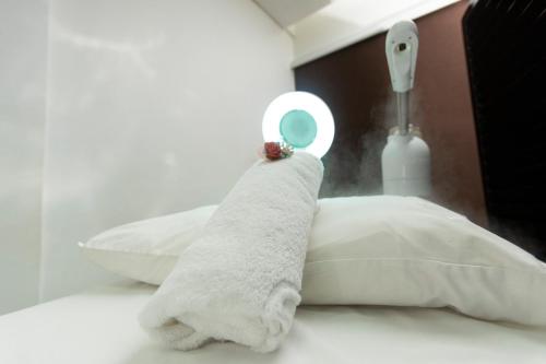 a white towel sitting on top of a bed at Best Western Premier Accra Airport Hotel in Accra