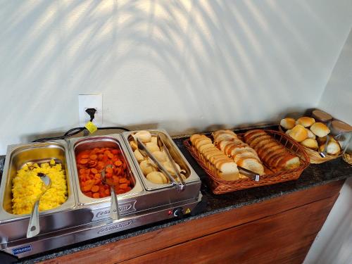 a buffet with different types of food on a counter at Pousada avenida in Urubici