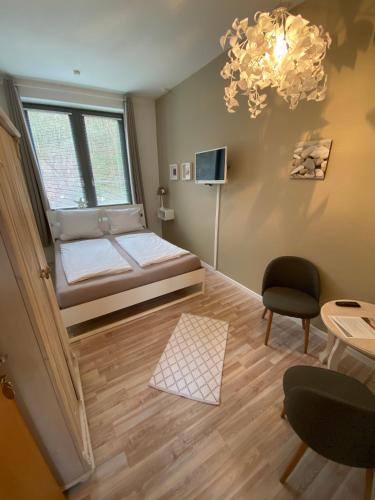 a living room with a bed and a window at Gästehaus Lavendel in Flensburg