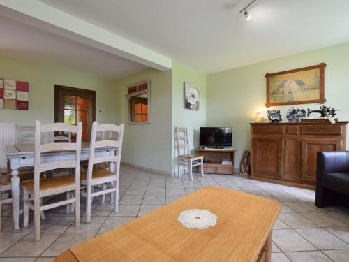 a living room with a table and a dining room at Holiday Home in Ardennes with Sauna in Jehonville