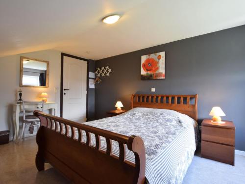 a bedroom with a large bed and two night stands at Holiday Home in Ardennes with Sauna in Jehonville