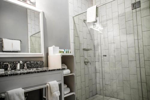 a bathroom with a shower and a sink at Bluegreen Vacations Club La Pension in New Orleans