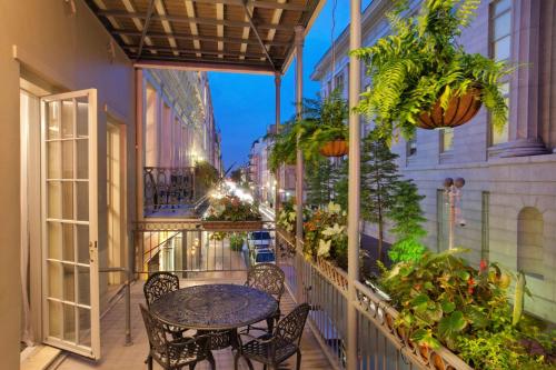 a balcony with a table and chairs and plants at Bluegreen Vacations Club La Pension in New Orleans