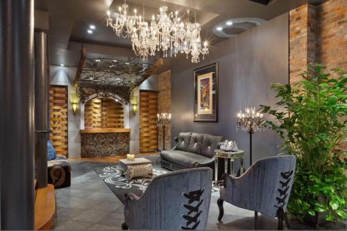 a living room with a couch and a chandelier at Bluegreen Vacations Club La Pension in New Orleans