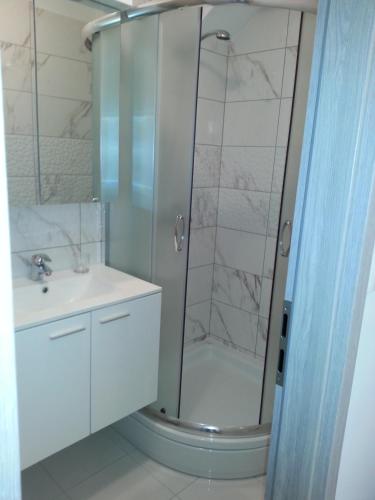 a bathroom with a shower and a sink at Apartments Mateljan 1715 in Kaštela