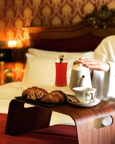 a tray with a plate of food on a table at Envy Hotel in Durrës