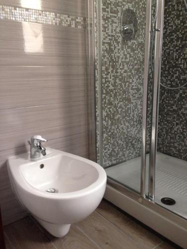 a bathroom with a white sink and a shower at Hotel Bologna in Genova