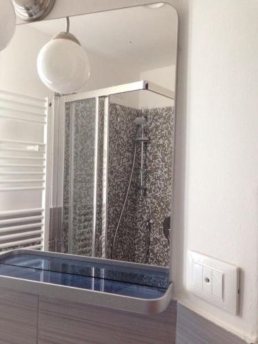 a mirror in a bathroom with a tub at Hotel Bologna in Genova