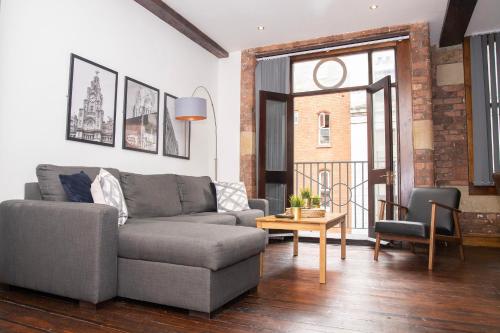 a living room with a couch and a table at 27 Stanley Street Aparthotel by UStay in Liverpool