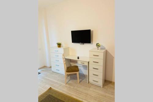 a bedroom with a desk with a tv on top of it at SEAWAVE CAMPUS no parking in Constanţa