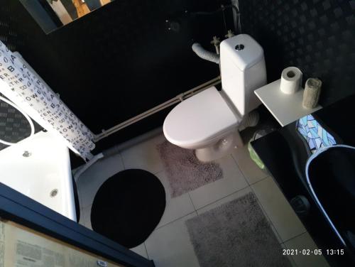 a small bathroom with a toilet and a sink at Guest House Serena in Chornomorsk