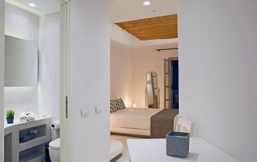 a bedroom with a bed and a bathroom at Thomais Studios in Naxos Chora