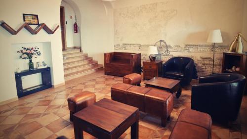 a waiting room with chairs and tables and a fireplace at Bed&Bike Prachatice in Prachatice