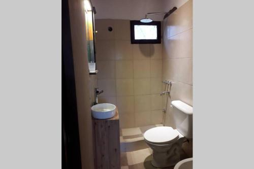 a small bathroom with a toilet and a sink at Rawson casa a minutos del centro y de Playa Unión in Rawson