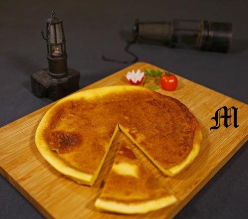 a pancake sitting on top of a wooden cutting board at Apartments at Gostilna Martin in Trbovlje
