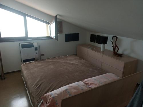 a bedroom with a large bed and a tv at Fronte mare in Marotta