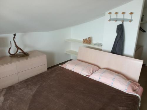 a bedroom with a bed and a dresser at Fronte mare in Marotta
