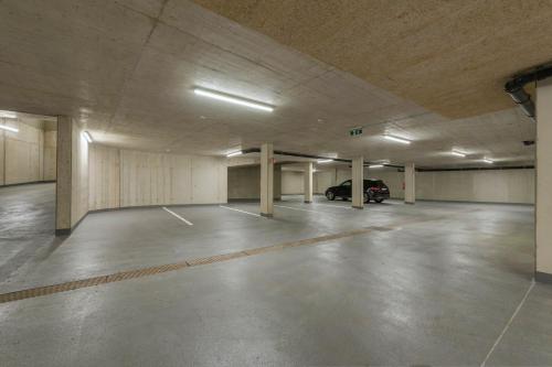 an empty parking garage with a car parked in it at Anthony's Peaks & Pillows in Sankt Anton am Arlberg