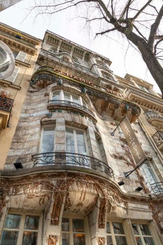 a building with a balcony on the side of it at Elysées Ceramic in Paris