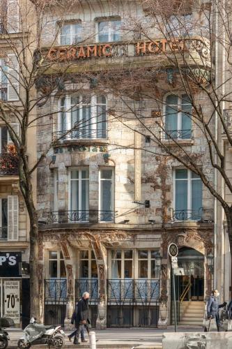 a man walking in front of a building at Elysées Ceramic in Paris