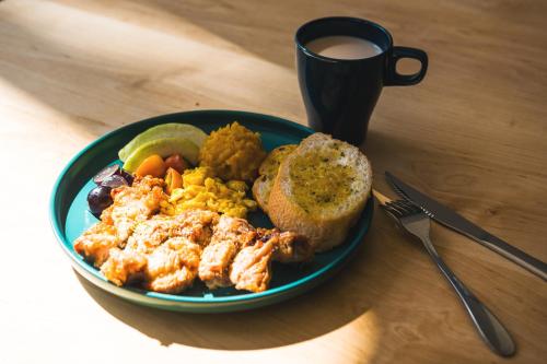 a plate of food on a table with a cup of coffee at Ren House大仁哥文旅 in Taitung City
