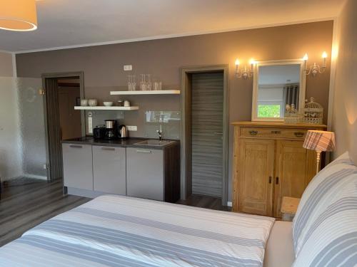 a bedroom with a bed and a kitchen with a counter at Weinburg -Das Ferienhaus in Cochem