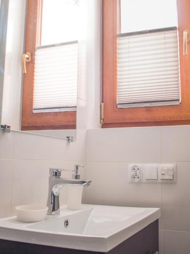 a bathroom with a sink and a mirror at OSADA Rokicie in Kluszkowce