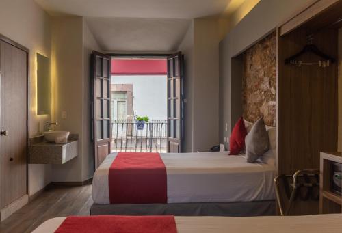 a hotel room with a bed and a balcony at Hotel Hidalgo in Querétaro